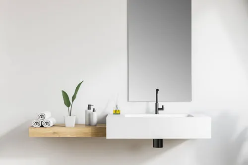 A large mirror installed on a bathroom wall