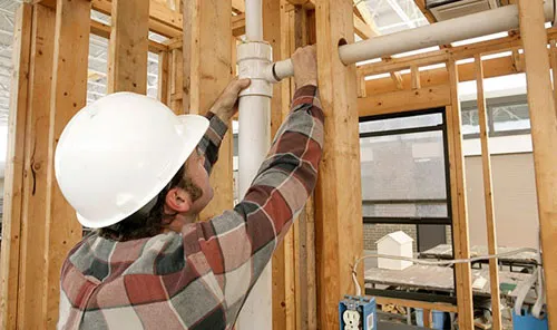A handyman laying a pipe
